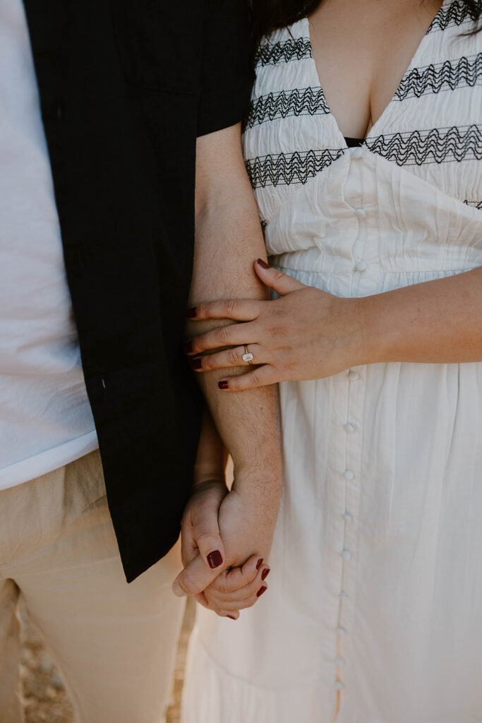 Couple holding hands during their session at sunset