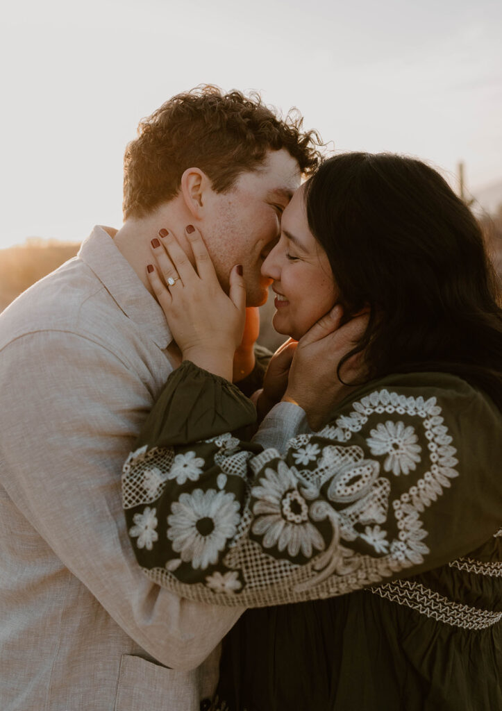 Engaged couple embracing in the desert at sunset — Tucson engagement photography