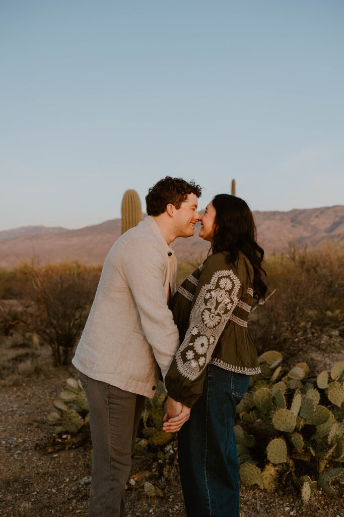 Engaged couple embracing in the desert at sunset — Tucson engagement photography