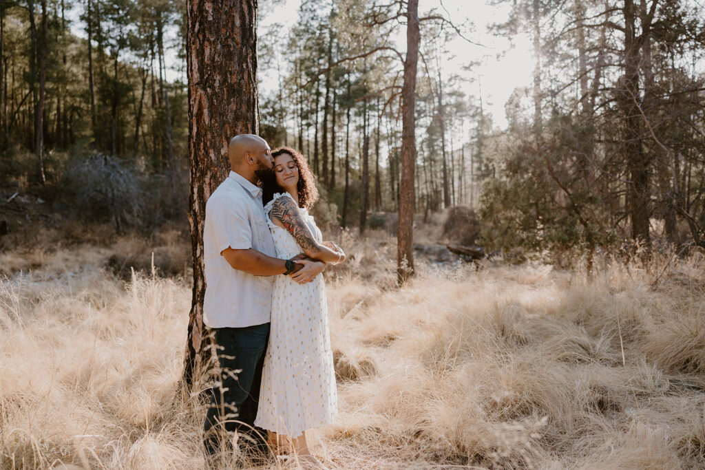 Couple holding hands during their Tucson engagement session at sunset