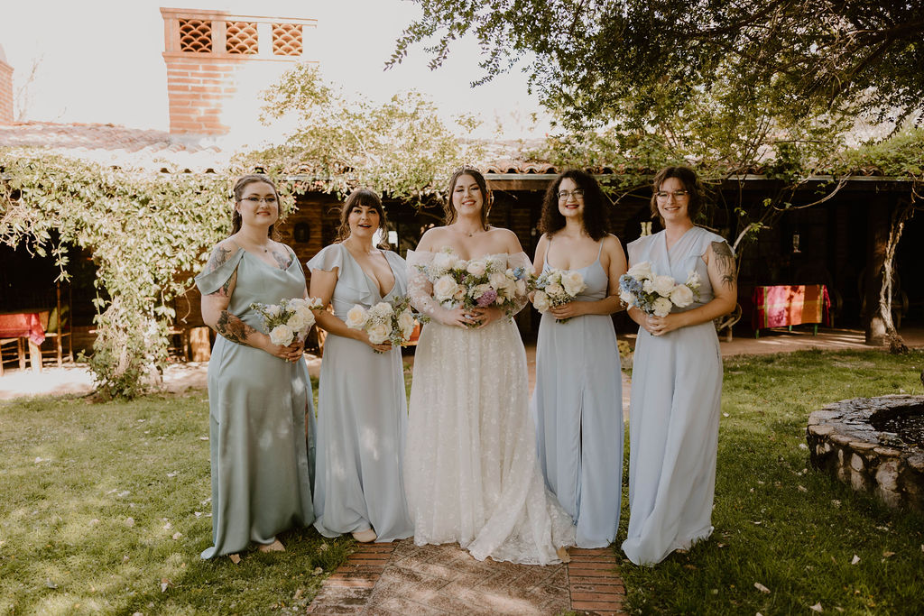 Tucson based, Arizona Micro Wedding Photographer takes garden party wedding photos bride and bridesmaid candid at Agua Linda Farm