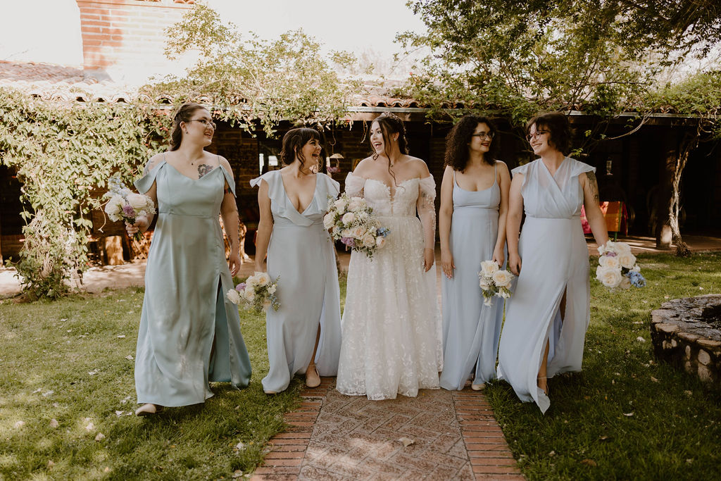 Tucson based, Arizona Micro Wedding Photographer takes garden party wedding photos bride and bridesmaid candid