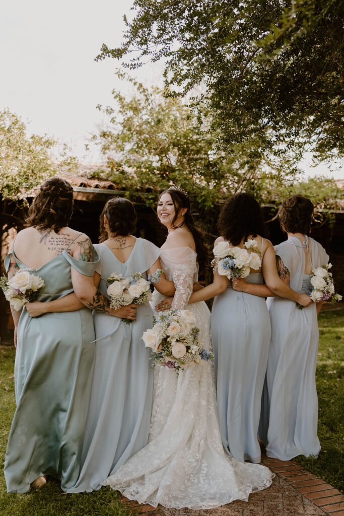 Tucson based, Arizona Micro Wedding Photographer takes garden party wedding photos bride and bridesmaid candid