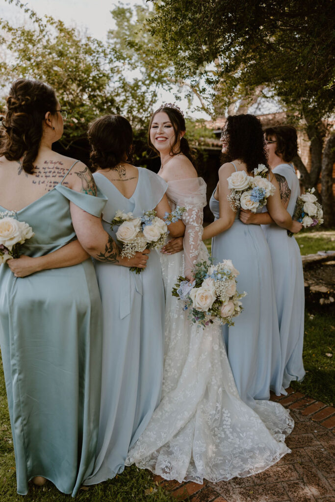 Tucson based, Arizona Micro Wedding Photographer takes garden party wedding photos bride and bridesmaid candid at Agua Linda Farm