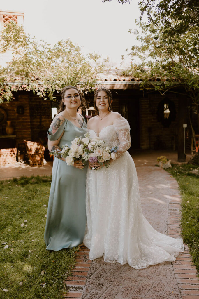 Tucson based, Arizona Micro Wedding Photographer takes garden party wedding photos bride and bridesmaid candid at Agua Linda Farm